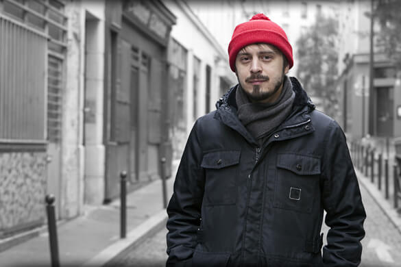 image of a man standing with a red hat